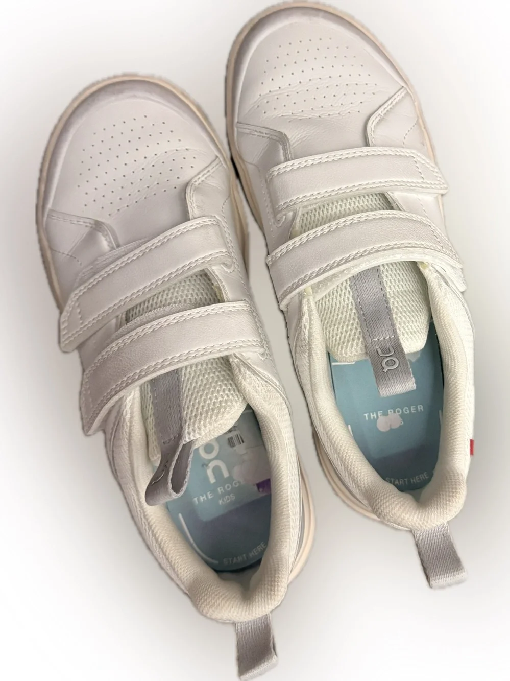 On Kids' The ROGER sneakers in a white colorway with double hook-and-loop Velcro